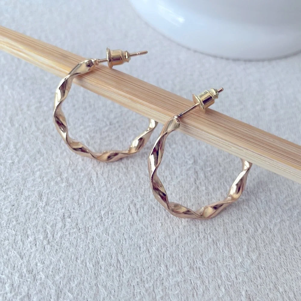 Medium twisted hoop gold earrings